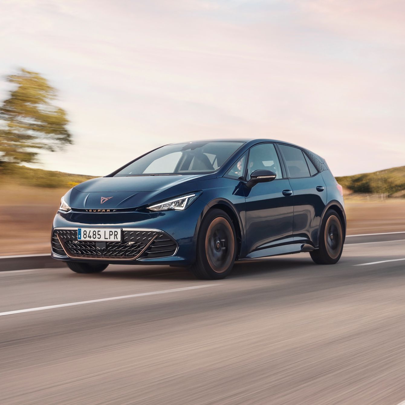 CUPRA Tavascan en un espacio de exposición moderno con iluminación ambiental púrpura