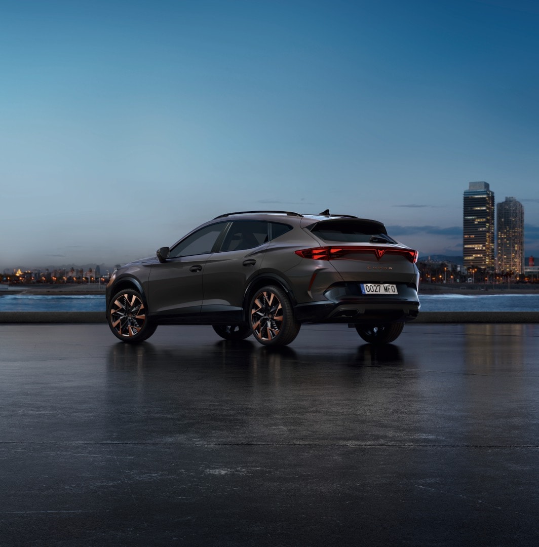 new cupra formentor offer, suv in century bronze matt, model year 2025, with 19 inch artic copper wheels and cityscape background. New car offers available.