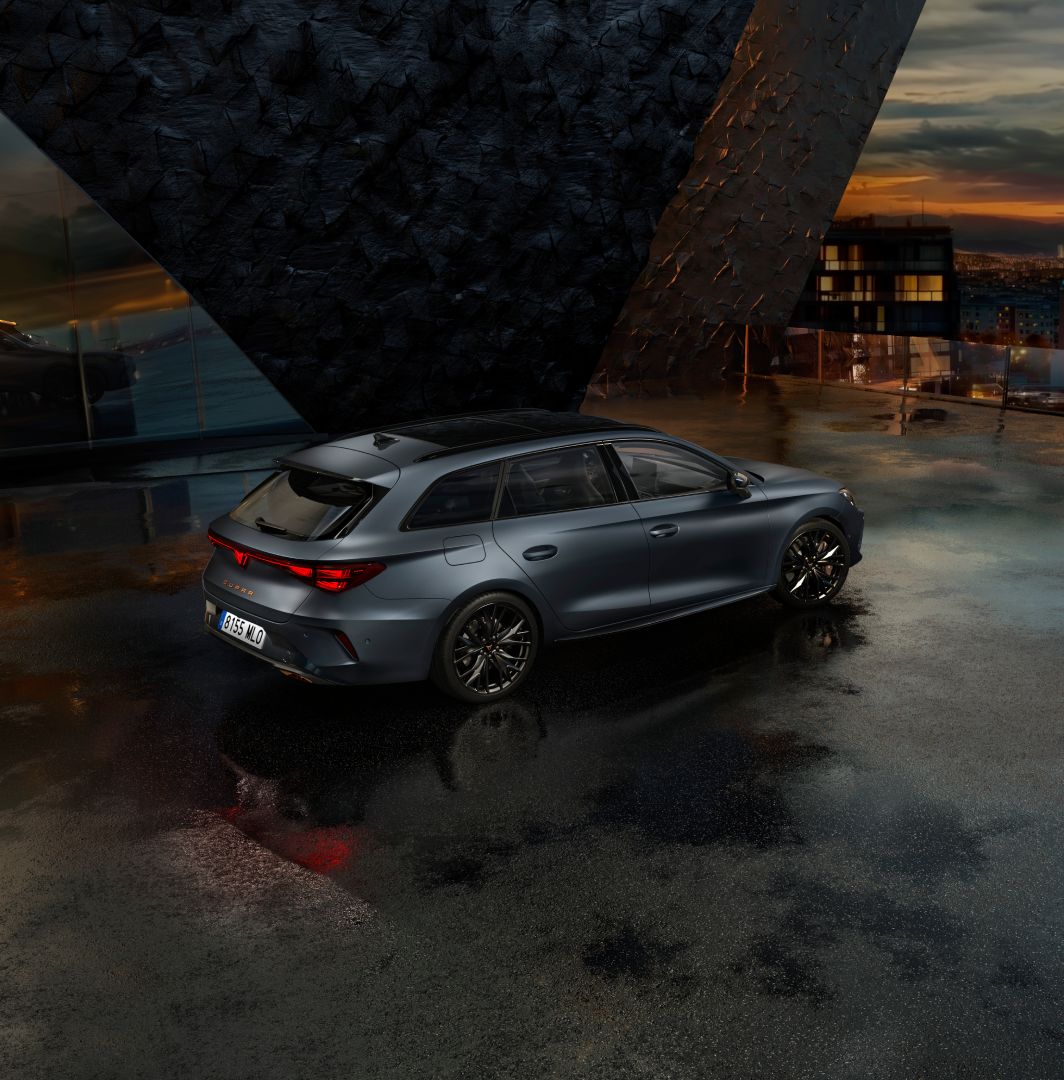 Cupra leon for sale, hatchback in magnetic tech matt grey with 19 inch polar copper wheels and illuminated city background. New car offers available.