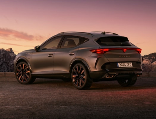 new cupra formentor offer, suv in century bronze matt, model year 2025, with 19 inch artic copper wheels and cityscape background. New car offers available.