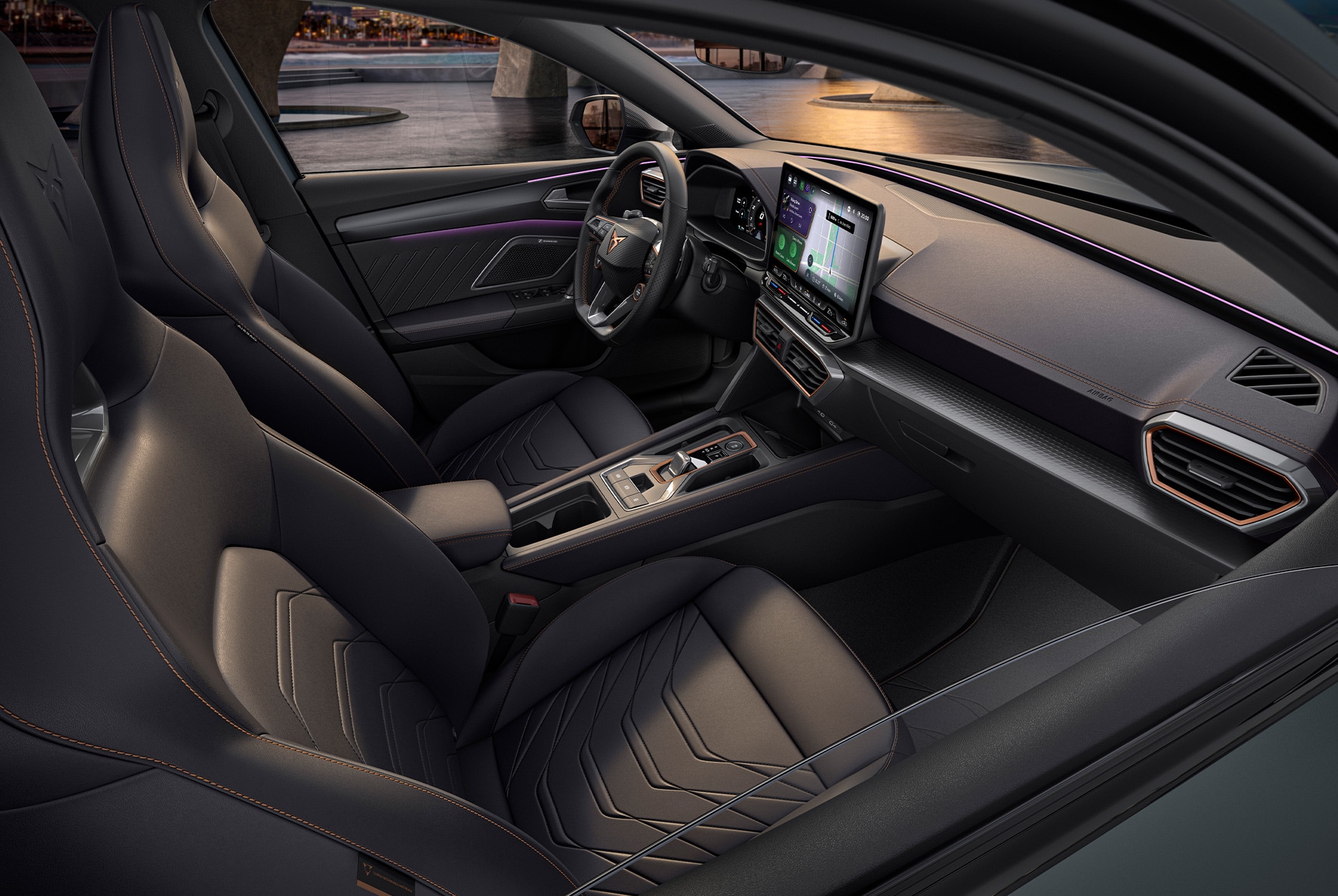 Interior of grey Cupra Leon Sportstourer, front passenger and driver seats, infotainment system, cupra wheel, bucket seats, at sunset.