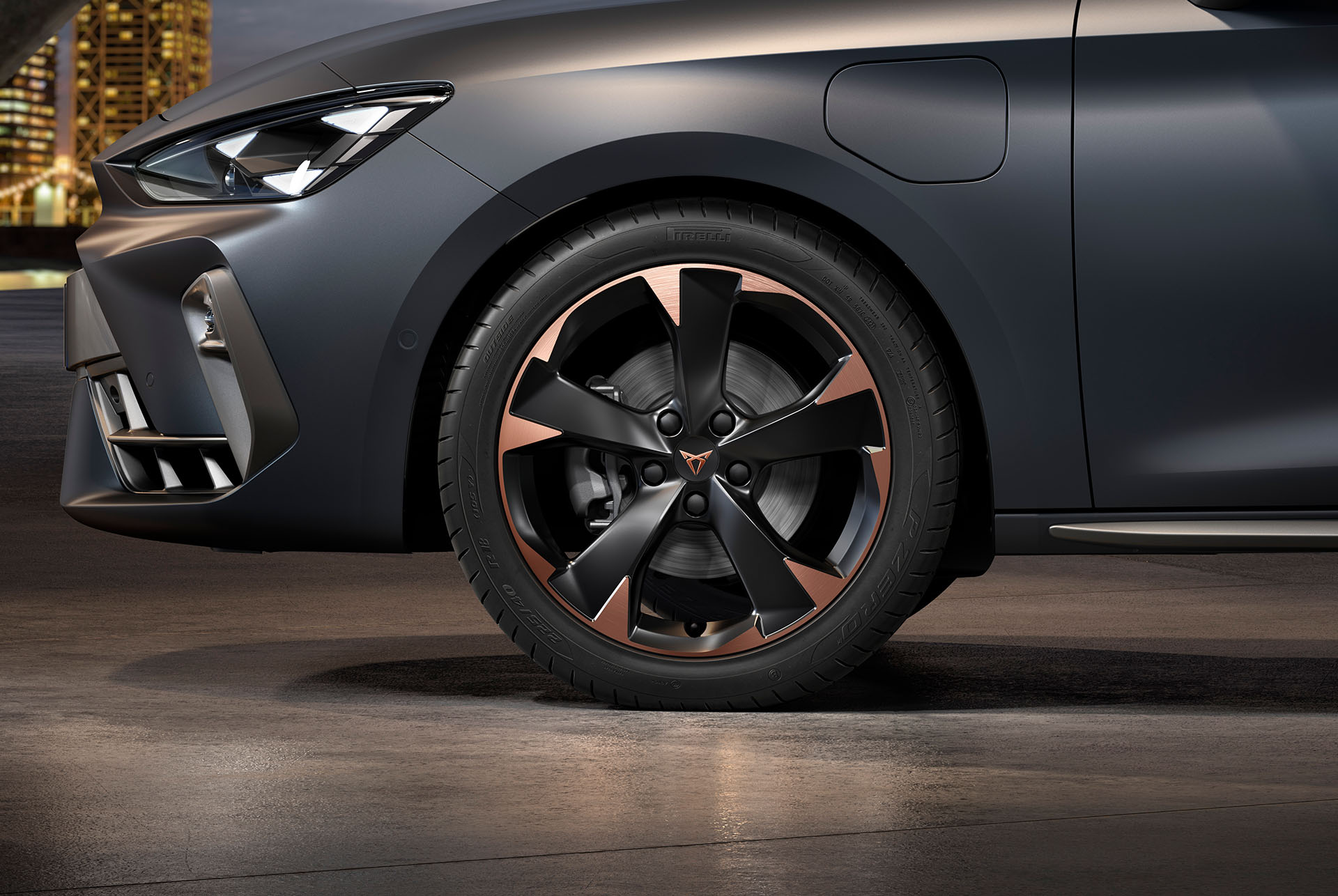 vista frontal lateral izquierda de las llantas de aleación mecanizadas Mistral Garbi Copper para el nuevo CUPRA León 2025, neumáticos, faros característicos y carrocería gris mate