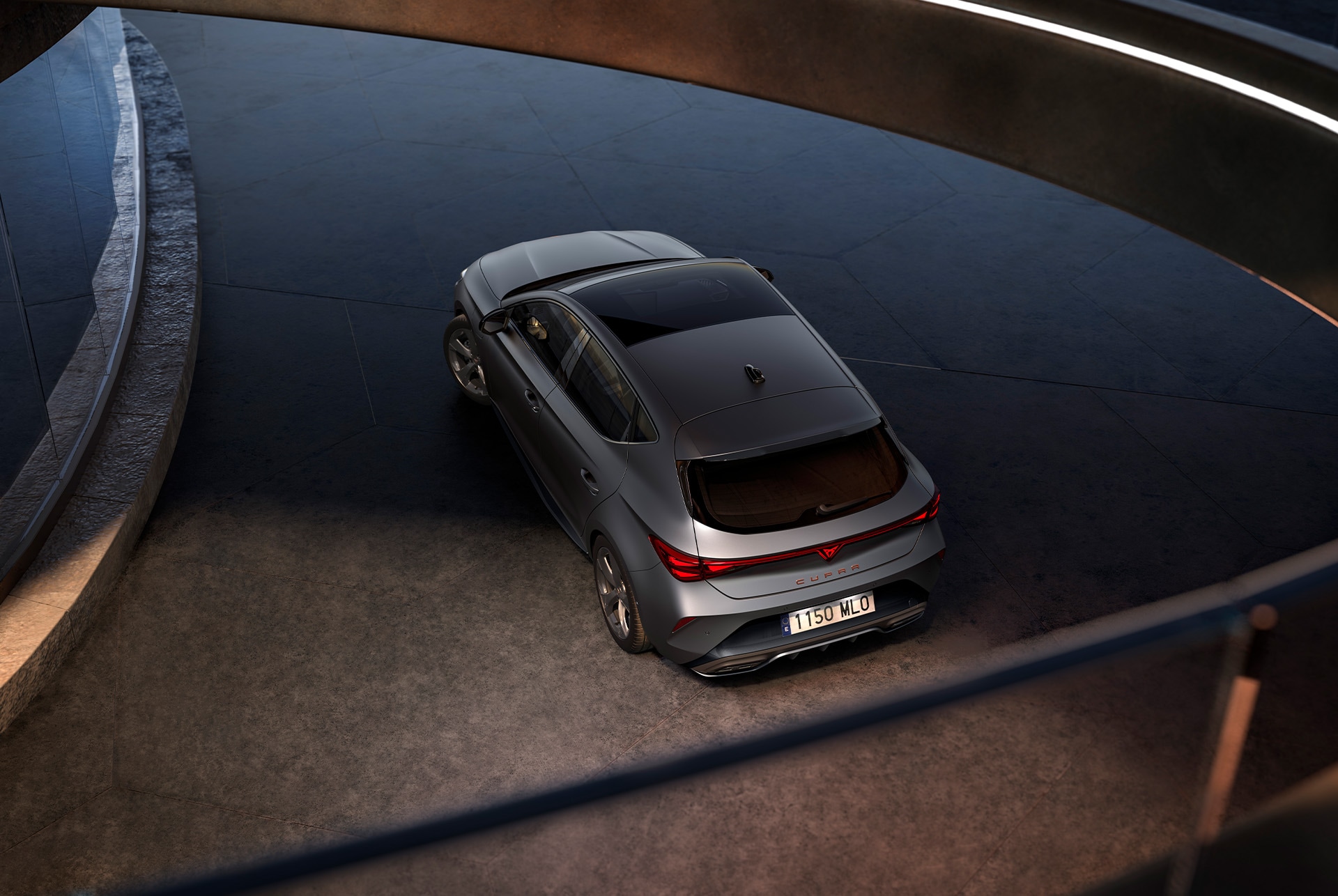 Vista frontal del vehículo CUPRA León en un ambiente oscuro con iluminación ambiental.