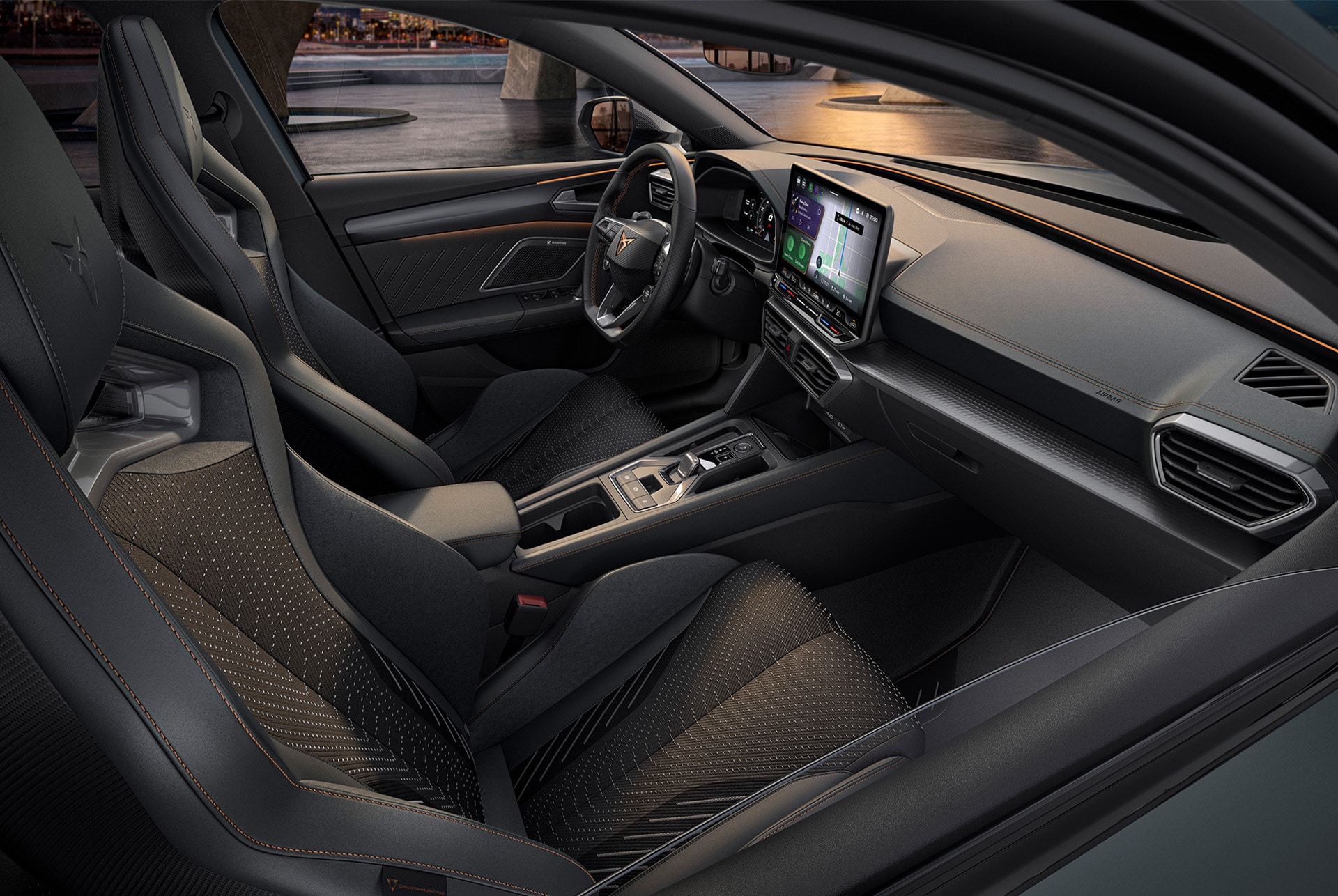 Interior del vehículo del CUPRA León, pantalla de Infotainment, asientos tipo bucket, asiento del acompañante y del conductor.