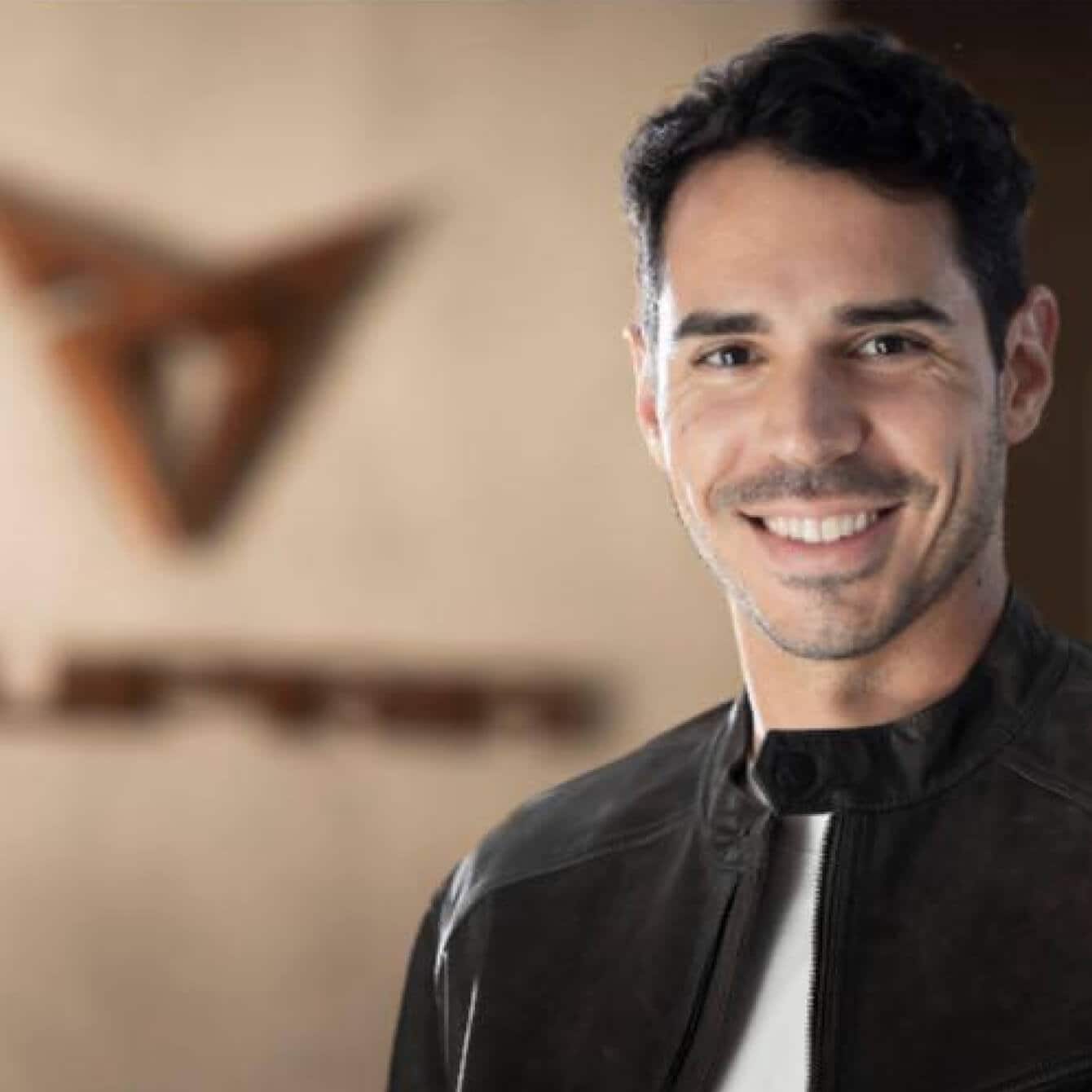 Miguel Diez, facing the camera with a background with the logo of CUPRA.