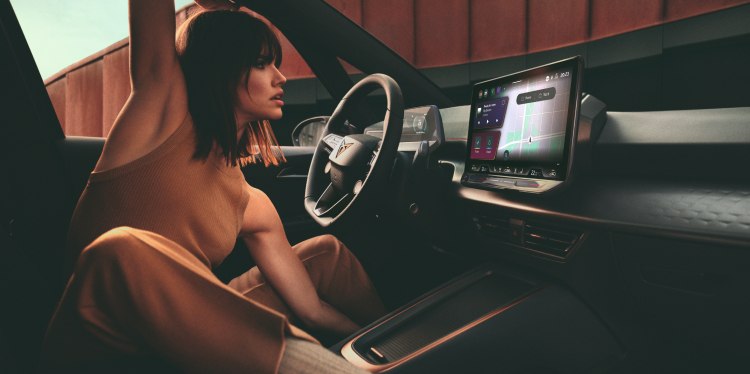A woman sitting comfortably in a  cupra car interior, interacting with the  infotainment system, highlighting modern  design and control with auto credit (pcp)