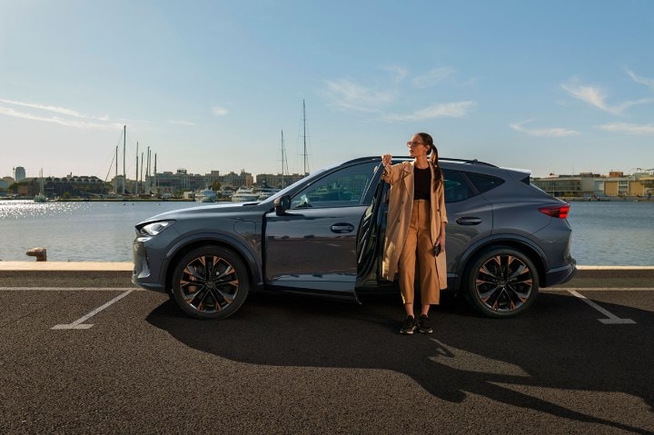 Woman exiting the cupra tavascan obtained through classical credit leasing with no balloon payment. Woman exiting the cupra tavascan obtained through classical credit leasing with no balloon payment.